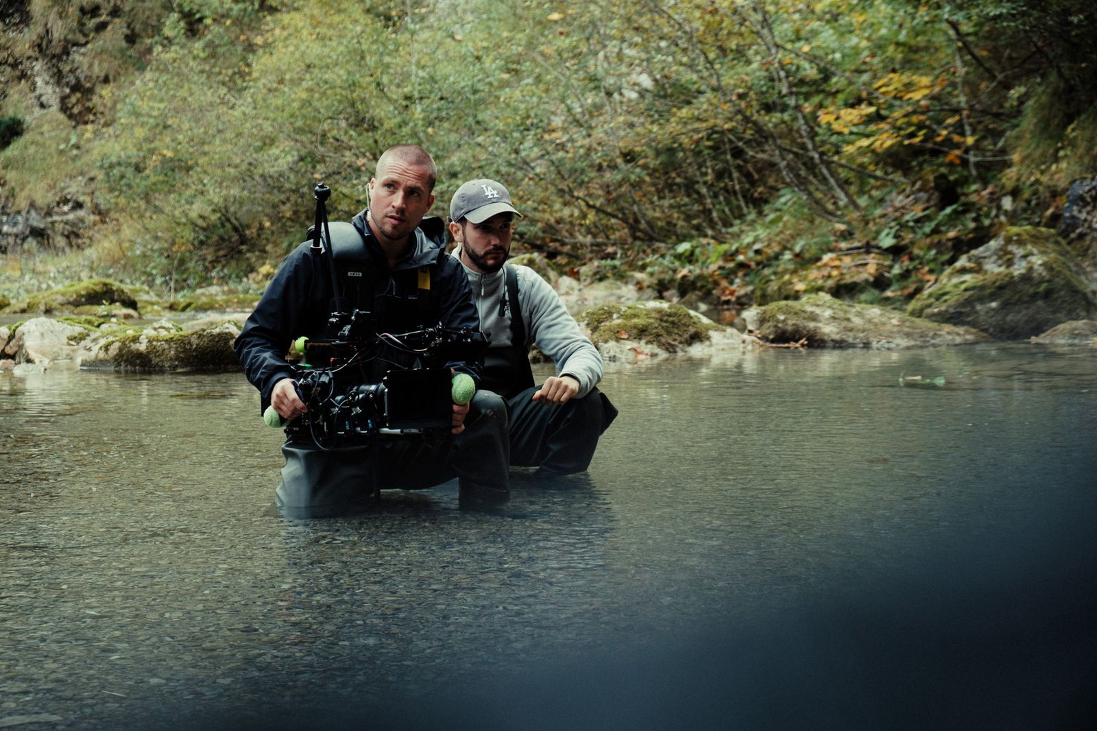 standing in the river with the camera